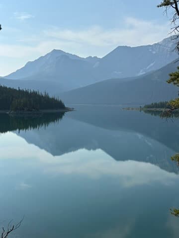 Mountain lake with perfect mirror reflection in the Canadian Rockies